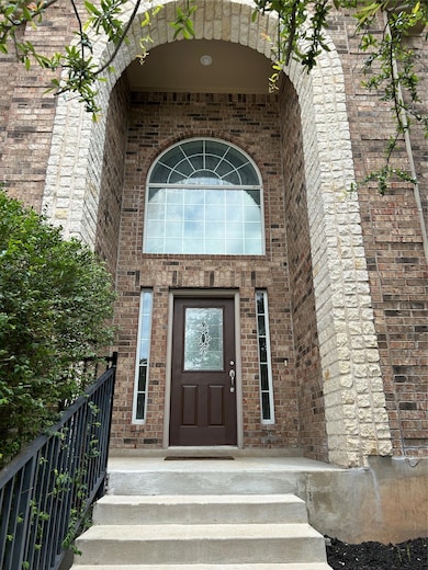 Doorway to property featuring brick siding