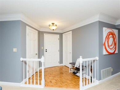 Spacious foyer with a walk in coat closet (L) and 