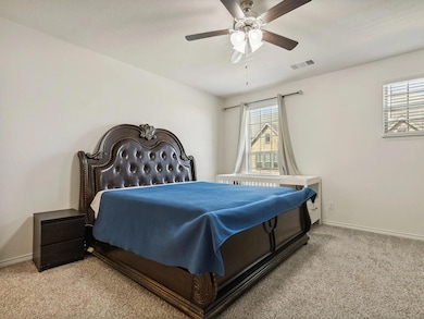 Bedroom featuring baseboards, visible vents, multi