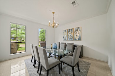 The formal dining room has marble floors and a cro