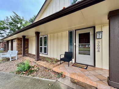 Property entrance featuring covered porch and board and batten siding