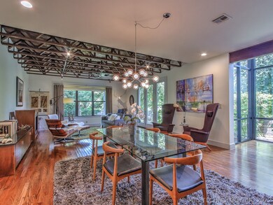 A spacious living room has windows that view the b