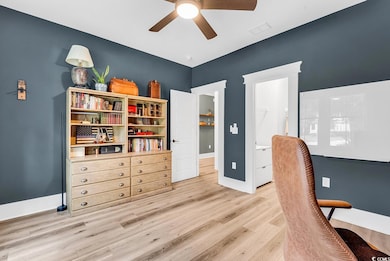 Office featuring ceiling fan, light wood-style flooring, and baseboards
