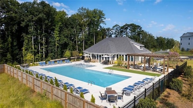 View of swimming pool featuring a patio area and a pergola