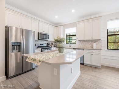 Kitchen featuring white cabinets, appliances with