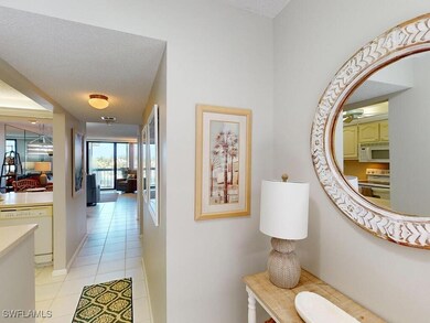Corridor featuring light tile patterned floors and