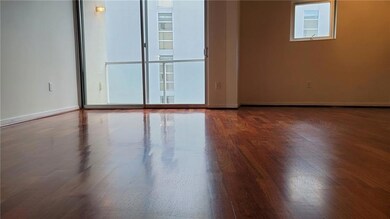 Spare room featuring baseboards and wood finished floors