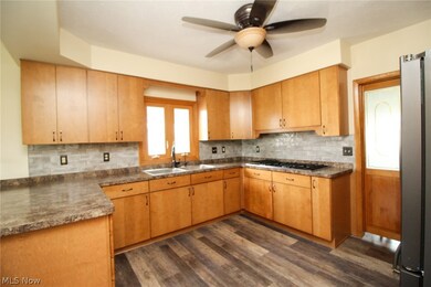 Kitchen with sink, ceiling fan, stainless steel appliances, and backsplash