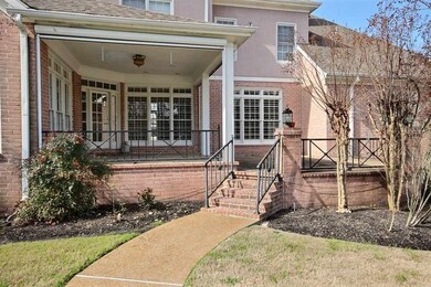 Backyard covered porch has a retractable screen! L
