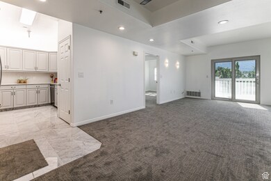 Unfurnished living room featuring recessed lighting and light carpet