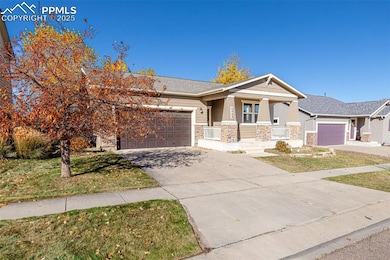 Craftsman-style home featuring a porch, stone siding, a front yard, and driveway