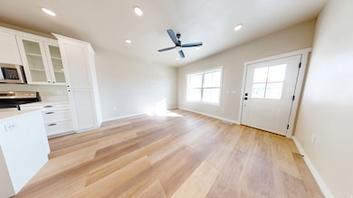 Unfurnished living room with recessed lighting, a ceiling fan, and light wood finished floors