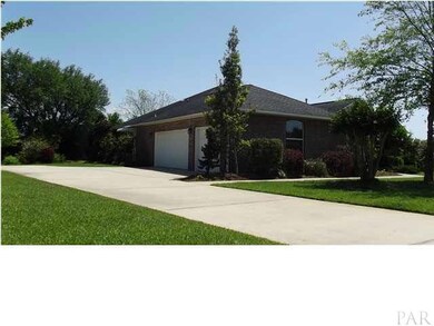 3 car oversized garage with additional parking pad.