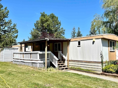 View of front of home with a front yard and covered porch