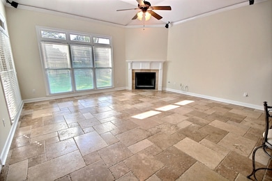 Unfurnished living room featuring crown molding, a