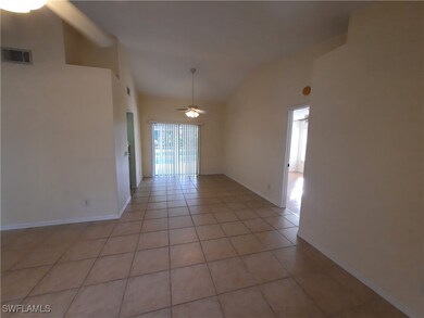 Spare room featuring a ceiling fan, vaulted ceilin