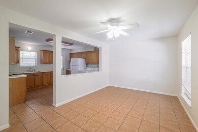 Unfurnished living room featuring ceiling fan, se