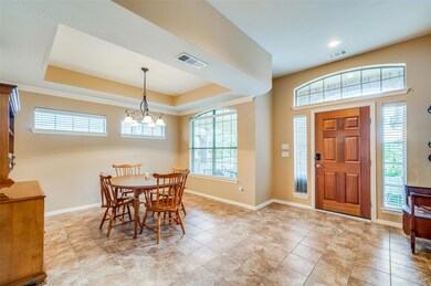 Tiled dining area with a raised ceiling, a healthy