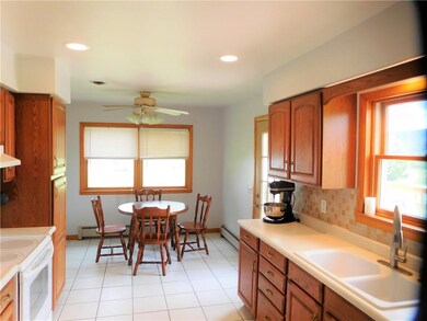 Eat-in kitchen is plenty large and has door to bal