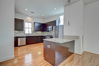 Huge Kitchen with updated glass tile backsplash, n