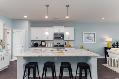 Kitchen featuring stainless steel appliances, a sink, a breakfast bar, tasteful backsplash, and recessed lighting