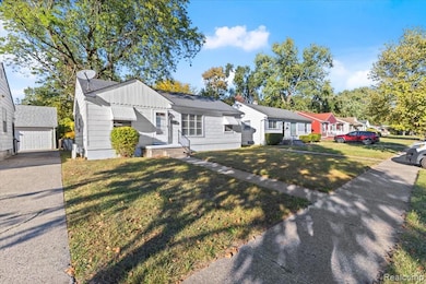 Ranch-style home featuring board and batten siding, a front yard, an outdoor structure, and a residential view