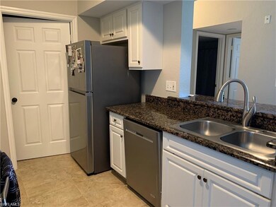 Kitchen with stainless steel dishwasher, sink, whi