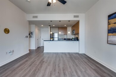 Unfurnished living room with sink, light wood-type