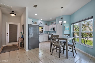 Dining area with a chandelier, light tile patterne