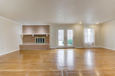 Unfurnished living room with light wood-style floo