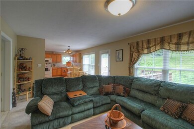 Family Room overlooks the back deck and opens to t