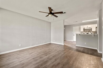 Unfurnished living room with ceiling fan and wood