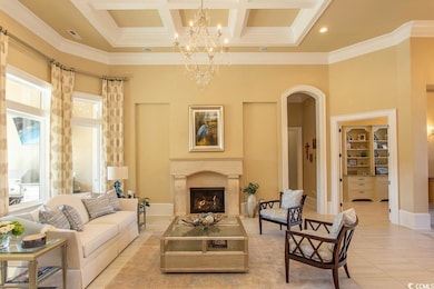 Living room with visible vents, coffered ceiling, a high end fireplace, arched walkways, and a high ceiling