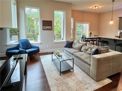 The view from the entry hall, looking on the great room, dining area, and the kitchen.