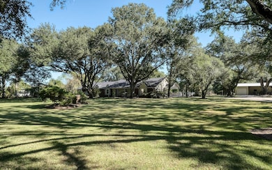 2 fenced acres with large scattered oaks.
