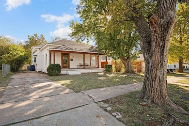 View of front of property with a porch, roof with shingles, and driveway