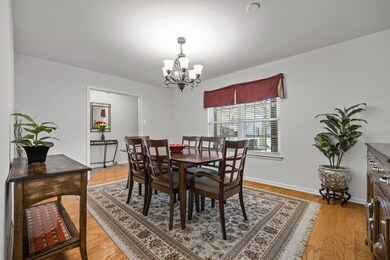 Dining room with light wood-style flooring and a chandelier