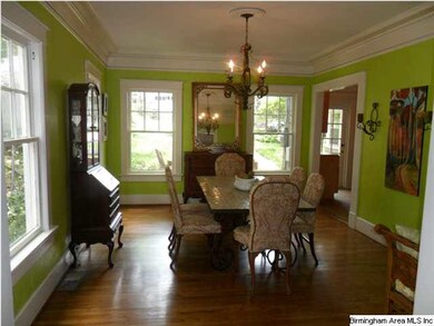 Dining room is so bright with 4 windows!  Hardwood