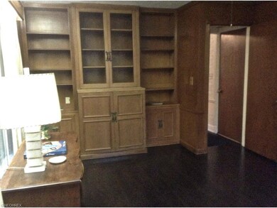 Handsome library with built-ins and hardwood floor