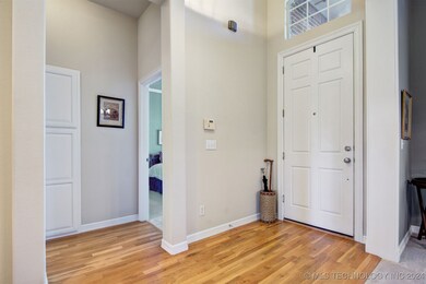 Entry with tall ceilings and hardwood flooring