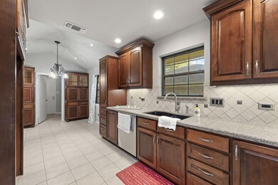 Kitchen with lofted ceiling, sink, stainless steel