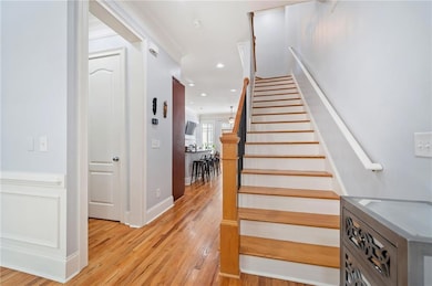 Staircase featuring hardwood flooring step treads 