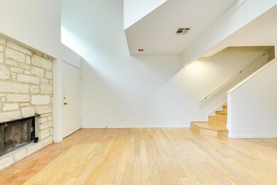 Unfurnished living room with a stone fireplace, b