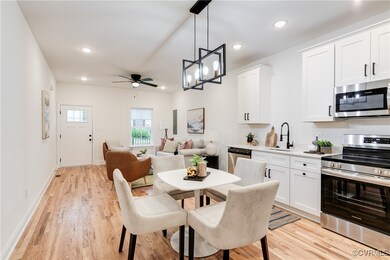 Dining space with ceiling fan with notable chandel