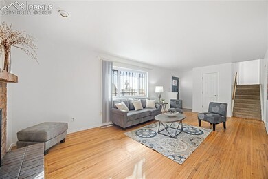 Living room with light wood-type flooring and a fi