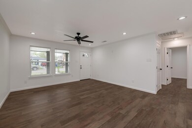 Unfurnished room with ceiling fan, dark wood-type 