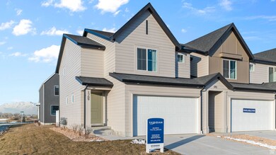 View of front facade with roof with shingles, a garage, and driveway