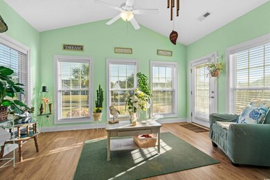 Sunroom with plenty of natural light and vaulted c