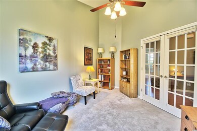 French doors open into the room with privacy blinds