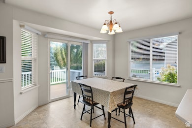 Dining area with healthy amount of natural light and a chandelier